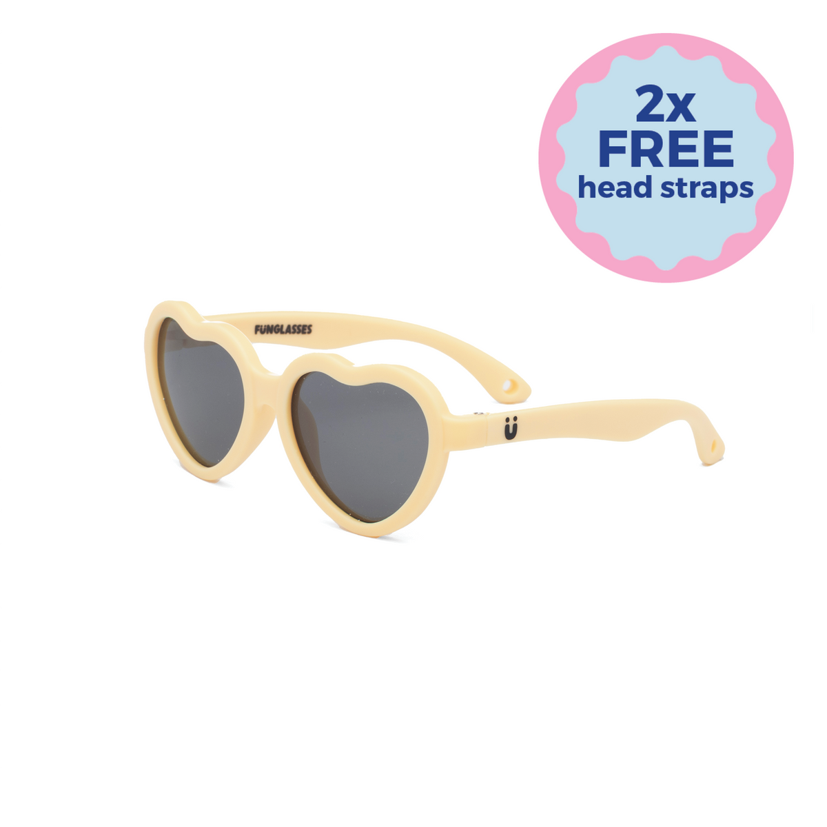 Heart-shaped kids sunglasses with yellow beige frame and dark lenses on a white background